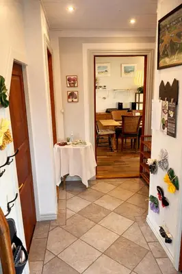 a room with a table and a dining room with a table and a kitchen at Cozy House Close to Beach and B&O in Struer