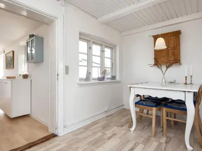 a white kitchen with a white table and a window at 10 person holiday home in Harboøre-By Traum in Harboør