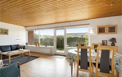a living room with a table and a couch at Awesome Home In Thyborøn With Wifi in Thyborøn