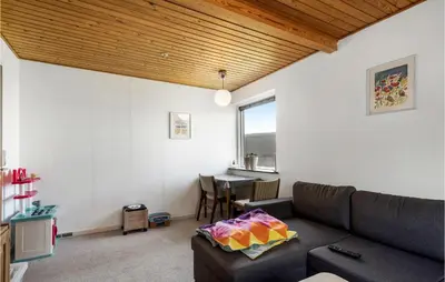 a living room with a couch and a table at Awesome Home In Thyborøn With Wifi in Thyborøn