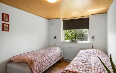a bedroom with two beds and a window at Awesome Home In Thyborøn With Wifi in Thyborøn