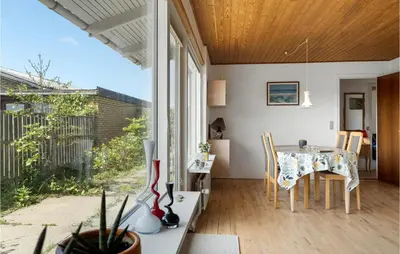 a dining room with a table and a large window at Awesome Home In Thyborøn With Wifi in Thyborøn