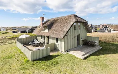 an old house with a thatched roof and a deck at Awesome Home In Harboøre With Wifi in Harboør