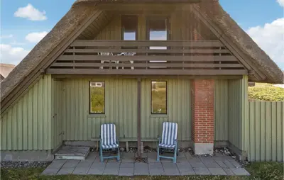 two chairs sitting on the porch of a house at Awesome Home In Harboøre With Wifi in Harboør
