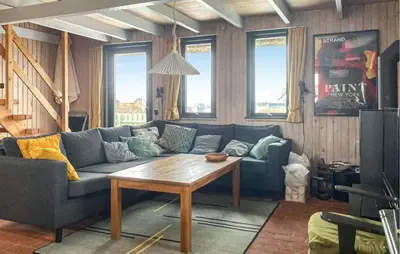 a living room with a couch and a table at Awesome Home In Harboøre With Wifi in Harboør