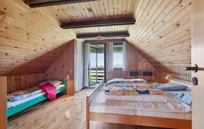 two beds in a room with wooden walls at Awesome Home In Harboøre With Wifi in Harboør