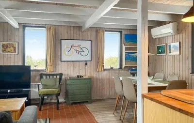 a living room with a dining table and a tv at Awesome Home In Harboøre With Wifi in Harboør