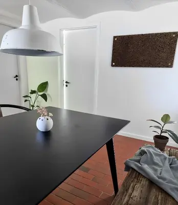 a black table with a vase on top of it at Calm and idyllic surroundings in Northen Jutland in Nibe