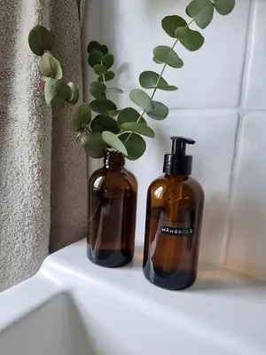 two bottles of soap sitting on top of a sink at Calm and idyllic surroundings in Northen Jutland in Nibe