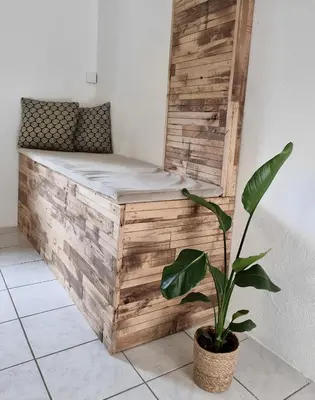a wooden bed in a room with a plant at Calm and idyllic surroundings in Northen Jutland in Nibe