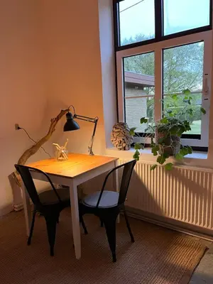 a desk with two chairs and a lamp and a window at Room 12 - Hawkraft Kulturhotel in Vestervig