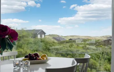 a table with a bowl of fruit and a window at Stunning Home In Løkken With Sauna in Løkken