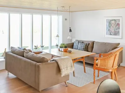 a living room with a couch and a table at Holiday Home Alkmar - 75m from the sea by Interhome in Thisted
