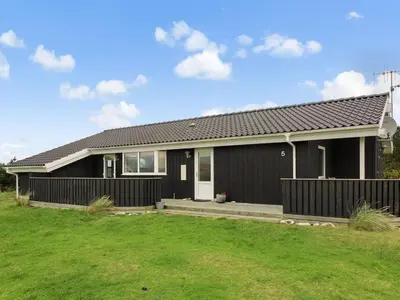 a home with a black house with a green yard at Holiday Home Appollina - 400m from the sea by Interhome in Torsted