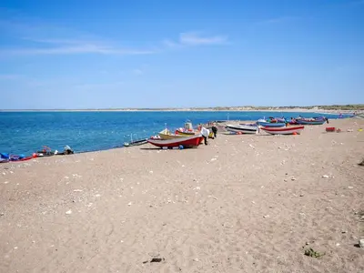 a group of boats sitting on a sandy beach at Holiday Home Appollina - 400m from the sea by Interhome in Torsted