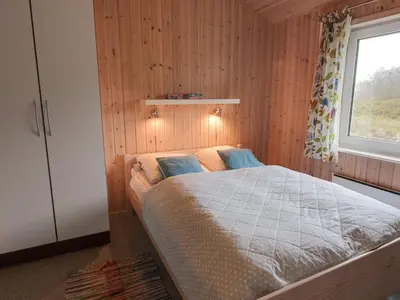 a bedroom with a bed and a window at Holiday Home Appollina - 400m from the sea by Interhome in Torsted
