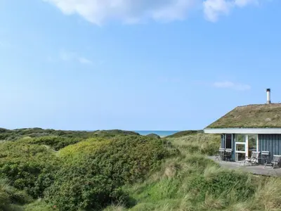 a house on the beach with a grass roof at Holiday Home Eunike - 220m from the sea by Interhome in Løkken