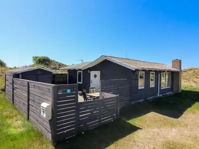 a house with a fence in front of it at Holiday Home Mira - 375m from the sea by Interhome in Løkken