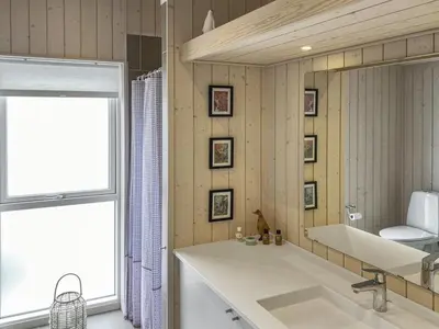 a bathroom with a large white sink and a window at Holiday Home Telma - 200m from the sea by Interhome in Blokhus