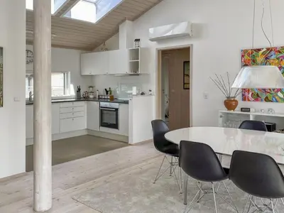 a kitchen and dining room with a table and chairs at Holiday Home Telma - 200m from the sea by Interhome in Blokhus