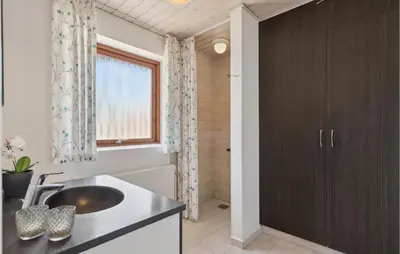 a bathroom with a sink and a shower at Nice Home In Bækmarksbro With Wifi in Bækmarksbro
