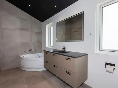 a bathroom with a sink and a bath tub at 10 person holiday home in Saltum-By Traum in Saltum