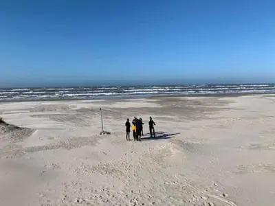 a group of people walking on the beach at 10 person holiday home in Saltum-By Traum in Saltum