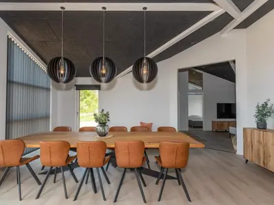 a dining room with a wooden table and chairs at 10 person holiday home in Saltum-By Traum in Saltum