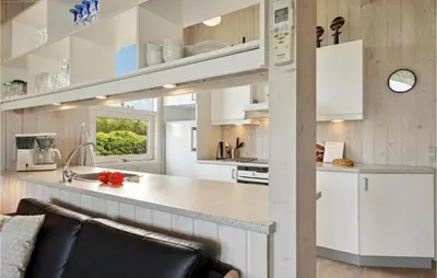 a kitchen with white cabinets and a counter top at 3 Bedroom Gorgeous Home In Farsø in Farsø