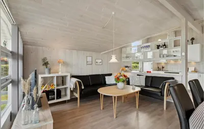 a living room with a couch and a table at 3 Bedroom Gorgeous Home In Farsø in Farsø