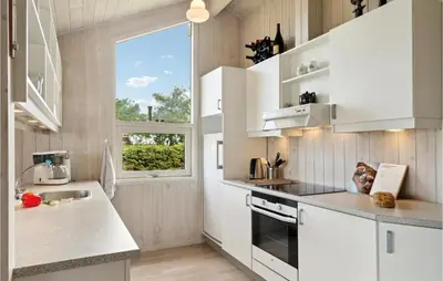 a kitchen with white cabinets and a window at 3 Bedroom Gorgeous Home In Farsø in Farsø