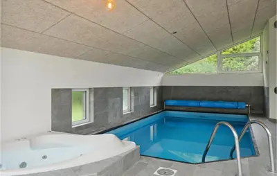 a swimming pool in a bathroom with a bath tub and a tub at Cozy Home In Farsø With Sauna in Farsø