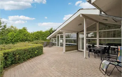 a pavilion with a table and chairs on a patio at Cozy Home In Farsø With Sauna in Farsø