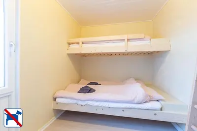 a small bedroom with two bunk beds in it at Agger Holidays in Vestervig