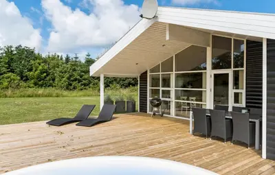a deck with chairs and a grill on a house at Pet Friendly Home In Saltum With Wifi in Saltum