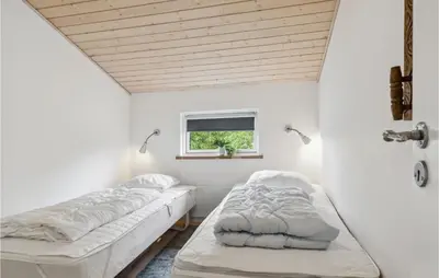 two beds in a room with a window at Pet Friendly Home In Saltum With Wifi in Saltum