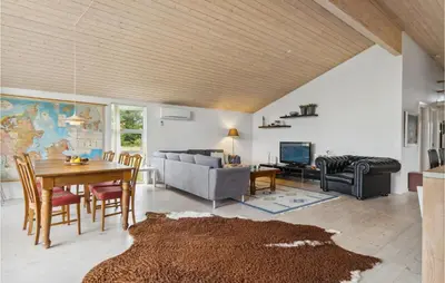 a living room with a table and a couch at Pet Friendly Home In Saltum With Wifi in Saltum