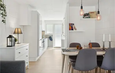 a kitchen and dining room with a table and chairs at Nice Apartment In Blokhus With Wifi in Blokhus