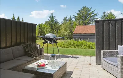 a barbecue grill sitting on top of a patio at Nice Apartment In Blokhus With Wifi in Blokhus