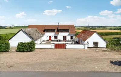 a white house with a brown roof at Beautiful Home In Farsø With Kitchen in Farsø