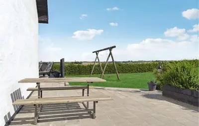 a picnic table with a swing and a playground at Beautiful Home In Farsø With Kitchen in Farsø