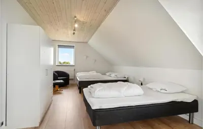three beds in a room with a ceiling at Beautiful Home In Farsø With Kitchen in Farsø
