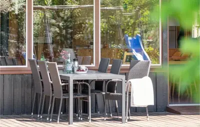 a table and chairs sitting on a patio at Gorgeous Home In Blokhus With Wifi in Blokhus