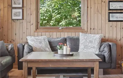 a living room with a leather couch and a coffee table at Gorgeous Home In Blokhus With Wifi in Blokhus