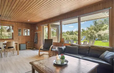 a living room with a couch and a table at Gorgeous Home In Blokhus With Wifi in Blokhus