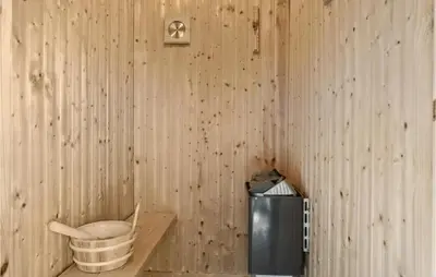 a room with a wooden wall with a bucket on a shelf at Gorgeous Home In Fjerritslev With Sauna in Fjerritslev