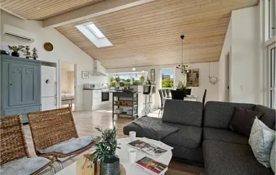 a living room with a couch and a table at Gorgeous Home In Fjerritslev With Sauna in Fjerritslev