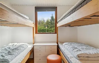 a bedroom with two bunk beds and a window at Beautiful Home In Struer With Kitchen in Struer