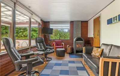 a living room with leather furniture and a fireplace at Beautiful Home In Struer With Kitchen in Struer