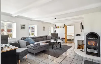 a living room with a couch and a fireplace at Beautiful Home In Thyborøn With Sauna in Thyborøn